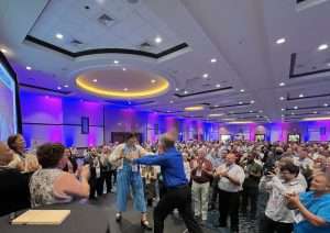 A Metz team member is seen breaking a board with Brian Brio, one of the nation’s foremost speakers