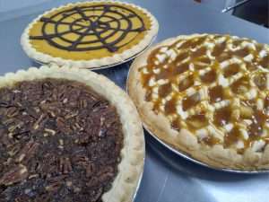 Left to right: Pecan, Pumpkin, and Caramel Apple Walnut pies cooling